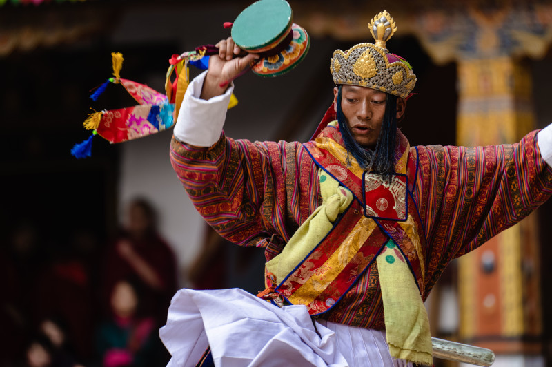 Bhutanese dancer in traditional dress performs at the Tshechu festival in Punakha.